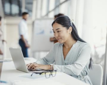 Woman typing on laptop